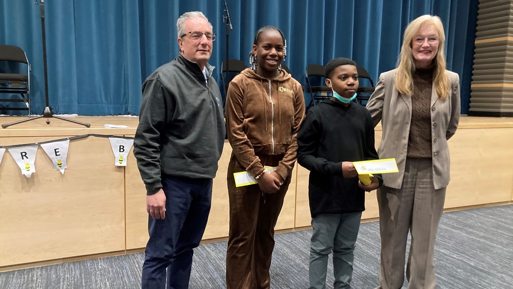 spelling bee winners posing with superintendent and mayor