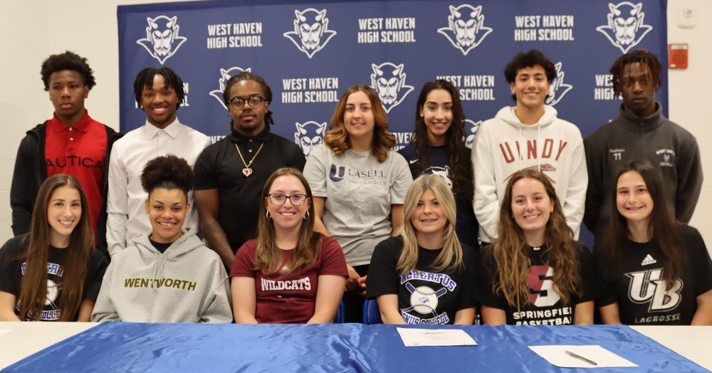 students posing for signing day