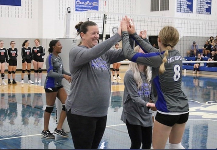 student playing volleyball