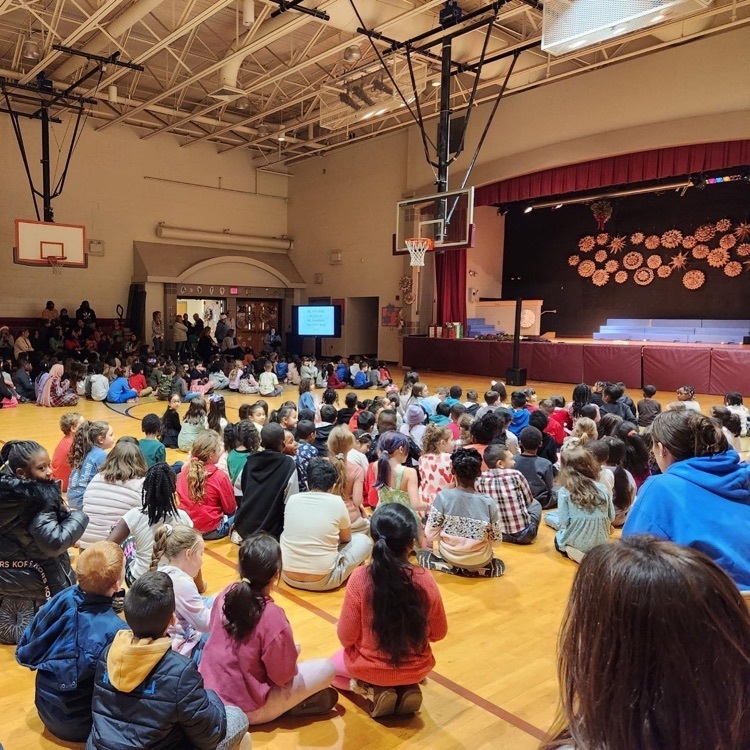 students sitting in gym