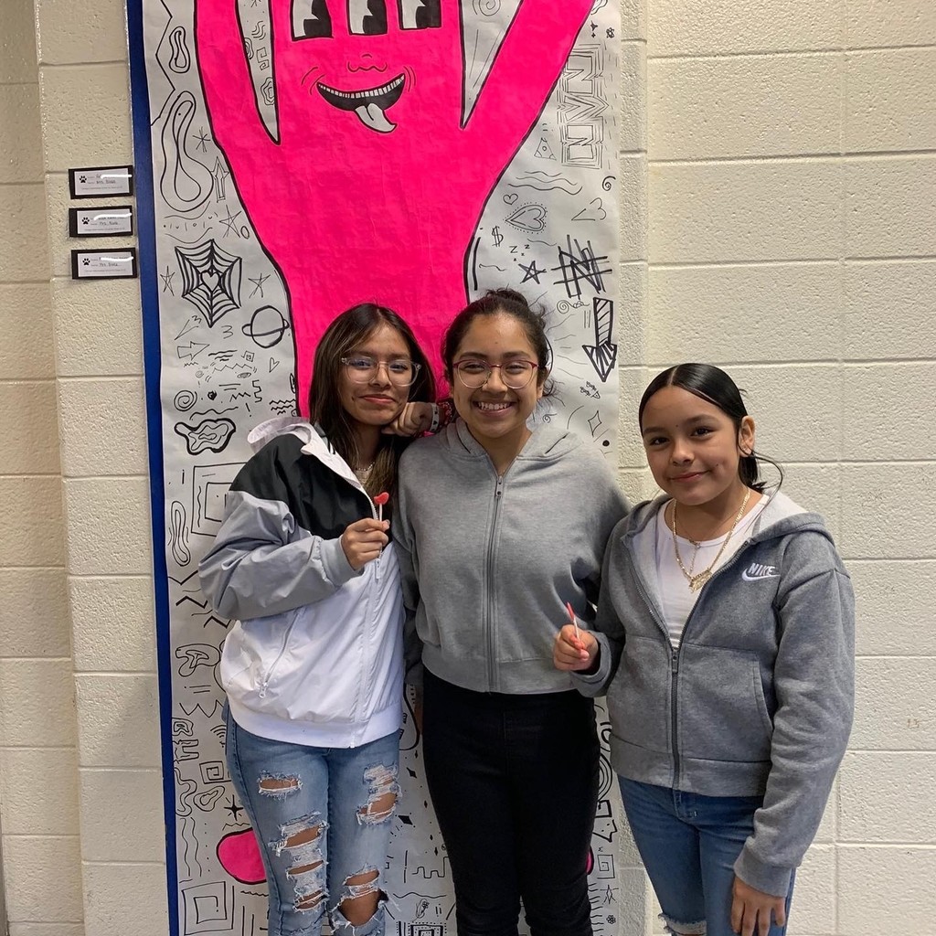 students posing at art show